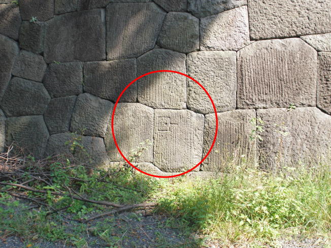 Stone marks carved into the stone walls inside the enclosure